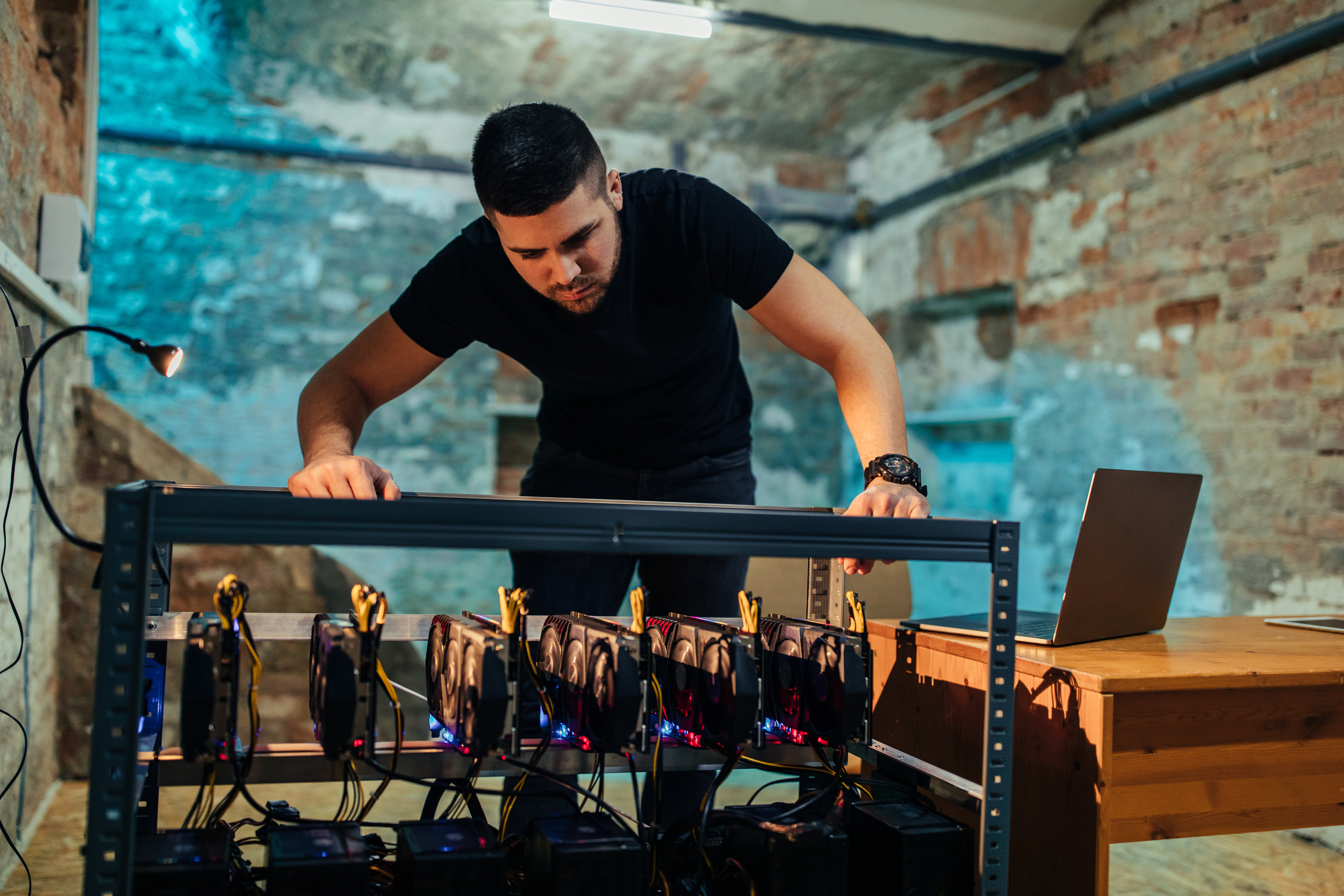 Shot of a young man looking at a cryptocoin mine
